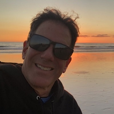 Dr. Weber taking a selfie on the beach during a sunset